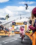Skiers jump over Tadej