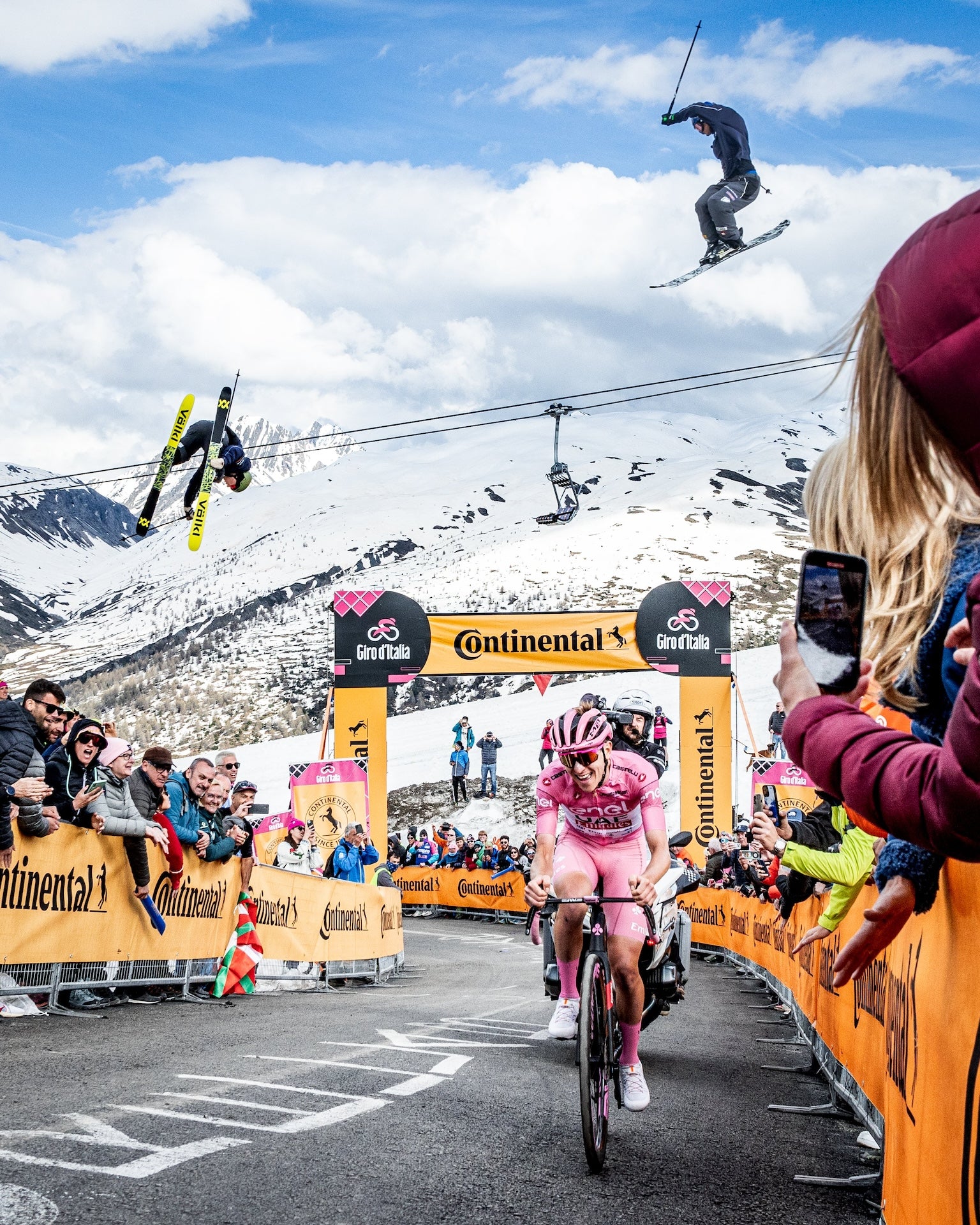 Skiers jump over Tadej